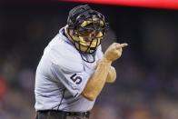 FILE - Home plate umpire Dale Scott signals during the seventh inning of a baseball game between the Detroit Tigers and the Los Angeles Angels, Wednesday, Aug. 26, 2015, in Detroit. A rule change at the beginning of the season designed to explain on-field call challenges and outcomes introduced umpires’ voices to ballpark speakers, to the fans in their seats and to the world at home for the first time. Scott, now retired, couldn't be more pleased. “I would have loved to have done it," he says. (AP Photo/Carlos Osorio, File)