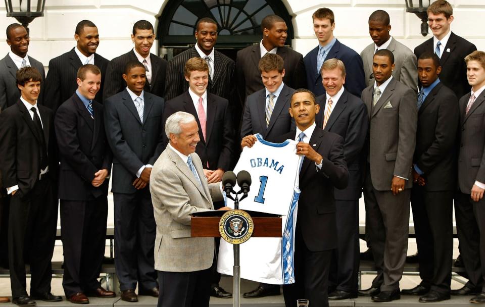 President Barack Obama accepts a team jersey at the White House on May 11, 2009, from the North Carolina Tar Heels, the 2009 NCAA Division I national champions, whom Obama picked to win in his March Madness bracket. <a href="https://www.gettyimages.com/detail/news-photo/university-of-north-carolina-mens-basketball-head-coach-roy-news-photo/87066338?adppopup=true" rel="nofollow noopener" target="_blank" data-ylk="slk:Chip Somodevilla/Getty Images;elm:context_link;itc:0;sec:content-canvas" class="link ">Chip Somodevilla/Getty Images</a>