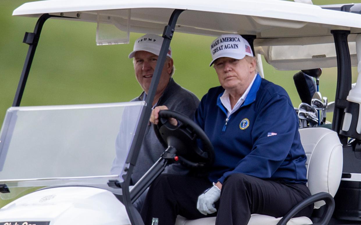 U.S. President Donald Trump golfs at Trump National Golf Club on Sunday in Sterling, Virginia - Getty