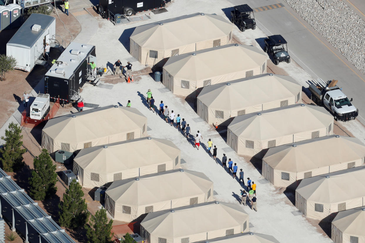 Immigrant children at a tent encampment in Tornillo,&nbsp;Texas, are seen walking single file on June 19. (Photo: Mike Blake/Reuters)