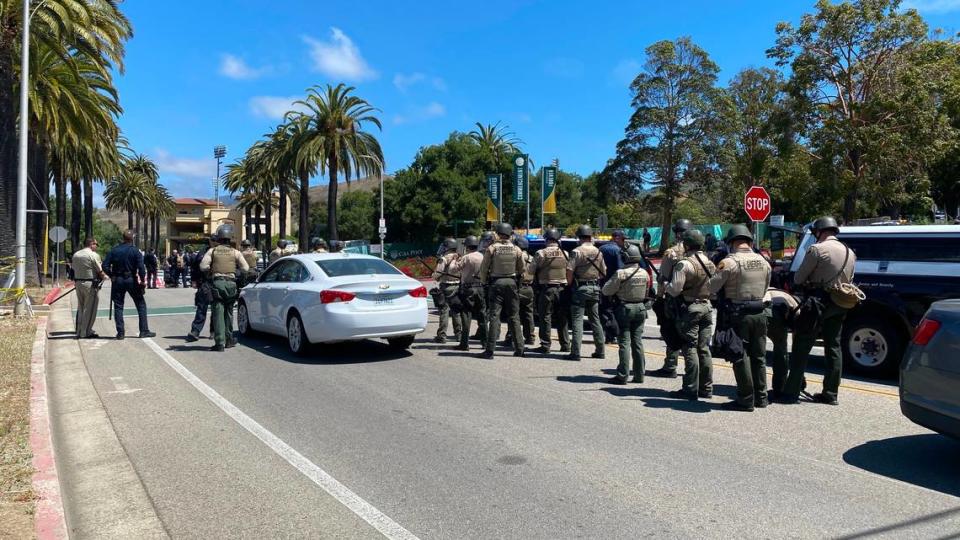 Sheriff’s deputies in riot helmets assemble as backup while detain eight pro-Palestine protesters who blocked the intersection at California Boulevard and Campus Way near Cal Poly on May 23, 2024.