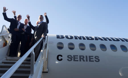 Airbus Chief Executive Tom Enders (2nd L) waves to employees as he stands on a C Series plane with Bombardier executives and other dignitaries at Bombardier's plant in Mirabel, Quebec Canada, October 20, 2017. REUTERS/Christinne Muschi