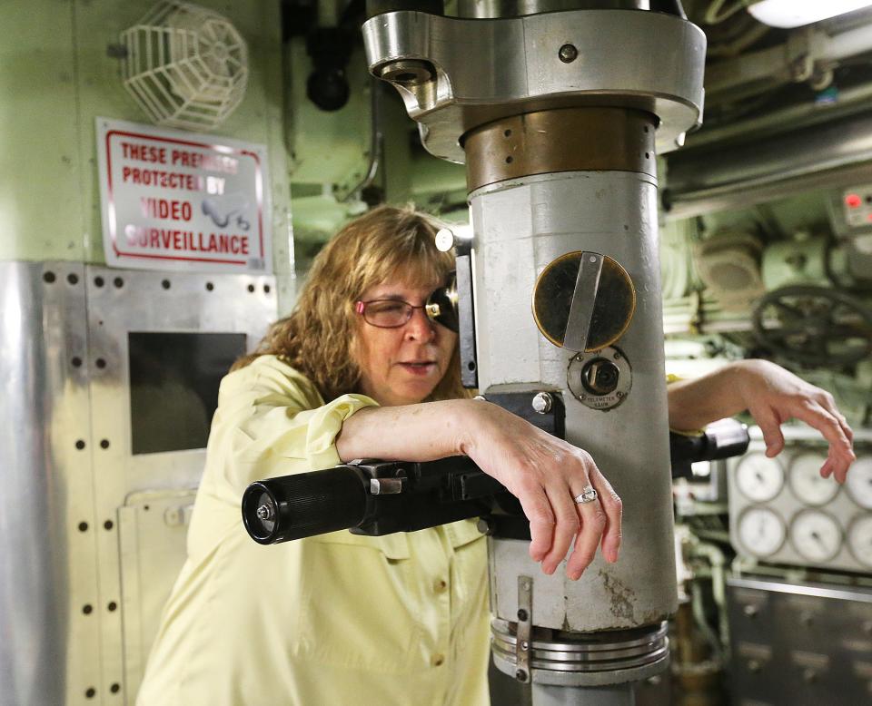 Patricia Violette-Adams, executive director of Albacore Park looks through the submarine's periscope Monday, May 22, 2023.