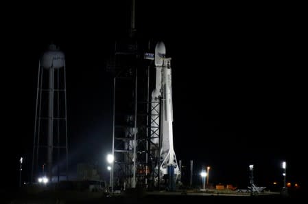 A SpaceX Falcon Heavy rocket, carrying the U.S. Air Force's Space Test Program 2 Mission, before its first nighttime liftoff from the Kennedy Space Center in Cape Canaveral