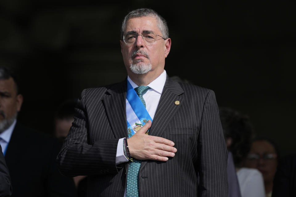 President Bernardo Arévalo listens the national anthem as he is acknowledged by the Army as the commander and chief at Constitution square in Guatemala City, Monday, Jan. 15, 2024, the morning after his inauguration. (AP Photo/Moises Castillo)