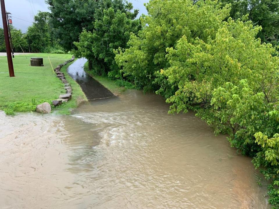 A portion of Crabtree Creek by Wake Forest Road overflows, flooding a section of a walking path, on Thursday, July 8, 2021.