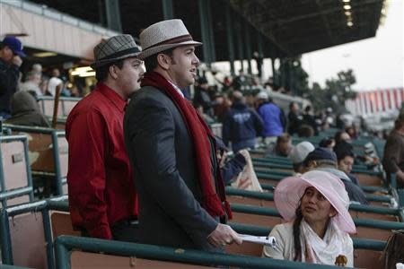 (L-R) Omar El Adli, Dean El Adli, and Vichea Chhuon handicap the 9th race at Betfair Hollywood Park, which is closing down at the conclusion of tomorrow's race card after operating for 75 years, in Inglewood, California December 21, 2013. REUTERS/Jonathan Alcorn