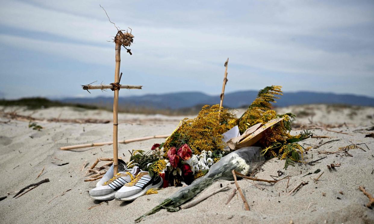 <span>A memorial on a beach near Cutro. Some people are still missing a year on from the tragedy.</span><span>Photograph: Tiziana Fabi/AFP/Getty Images</span>