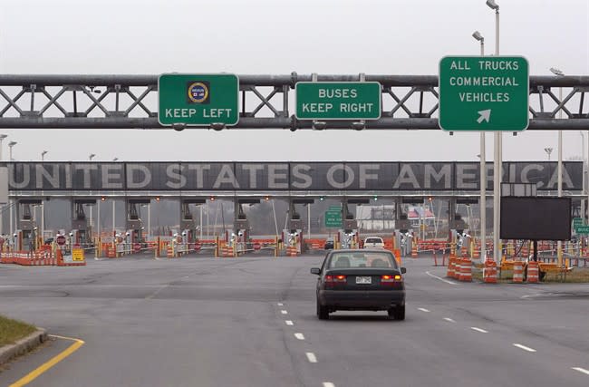 In this Dec. 7, 2011 photo, a car approaches the United States and Canada border crossing in Lacolle, Quebec. THE CANADIAN PRESS/Ryan Remiorz