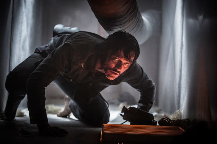 A man crawls in an air vent in High-Rise.