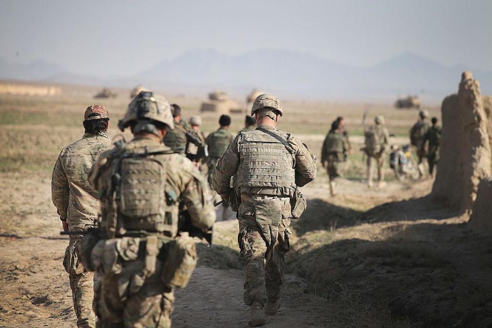 Soldiers with the U.S. Army's 4th squadron 2nd Cavalry Regiment and the Afghan National Army (ANA) return to their vehicles following a patrol through a village on March 5, 2014 near Kandahar, Afghanistan