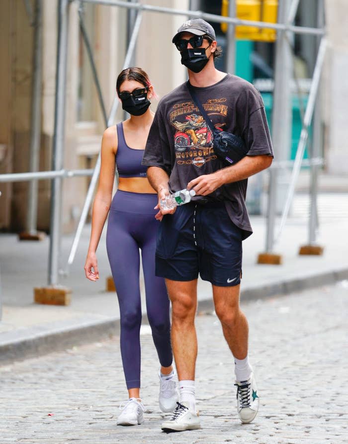 The couple walking down a street in workout gear