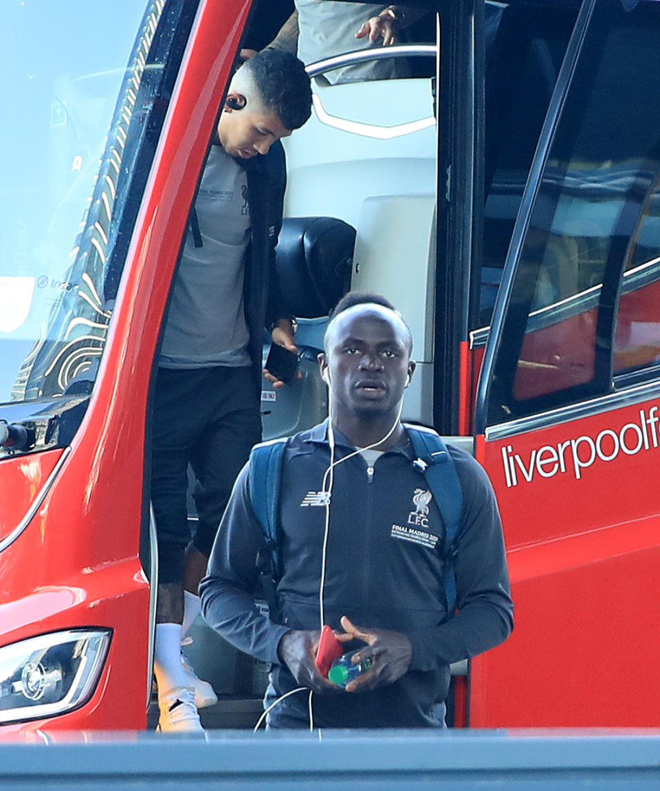 Liverpool's Roberto Firmino (left) and Sadio Mane step off the bus as they team arrive at their hotel in Madrid, Spain.