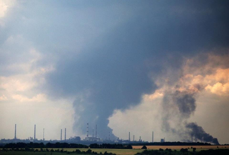 Smoke billows over the oil refinery outside the town of Lysychansk on June 23, 2022, amid Russia's military invasion launched on Ukraine.