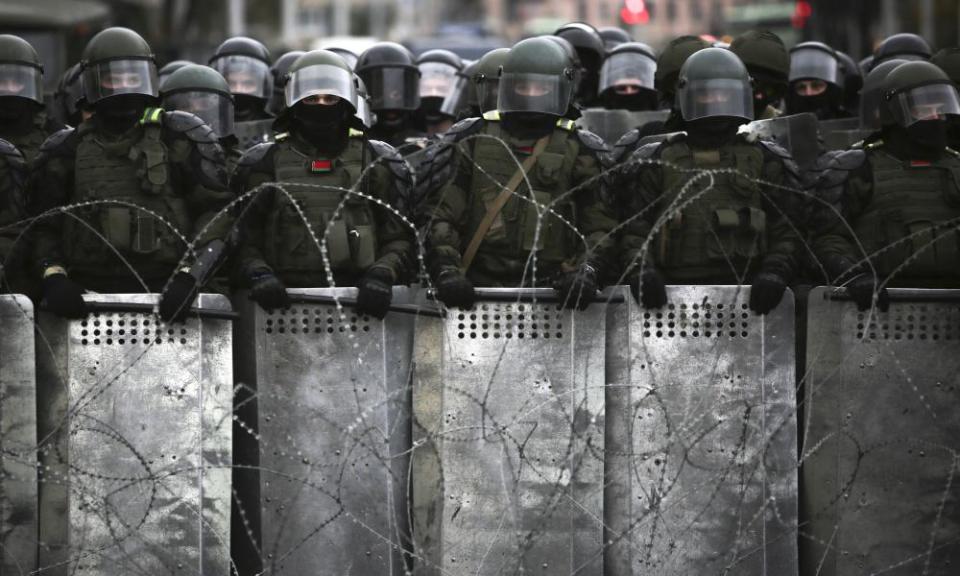 Belarusian police block a street during an opposition rally on 25 October