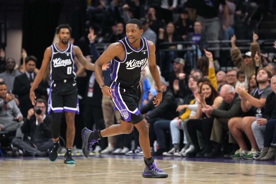 Dec 14, 2023; Sacramento, California, USA; Sacramento Kings guard De'Aaron Fox (5) reacts after making a three point basket against the Oklahoma City Thunder during the fourth quarter at Golden 1 Center. Mandatory Credit: Darren Yamashita-USA TODAY Sports