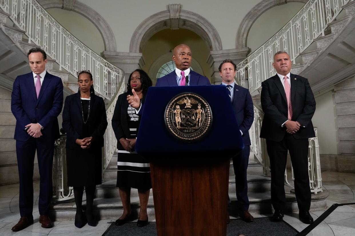 Mayor Eric Adams (center) delivers an address at City Hall on asylum seekers in lower Manhattan, New York on Friday, October 7, 2022. 