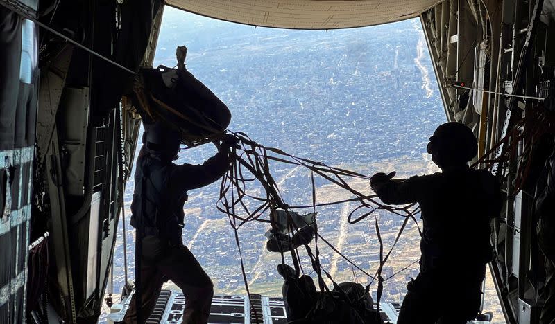 U.S. military personnel air drop aid parcels over Gaza