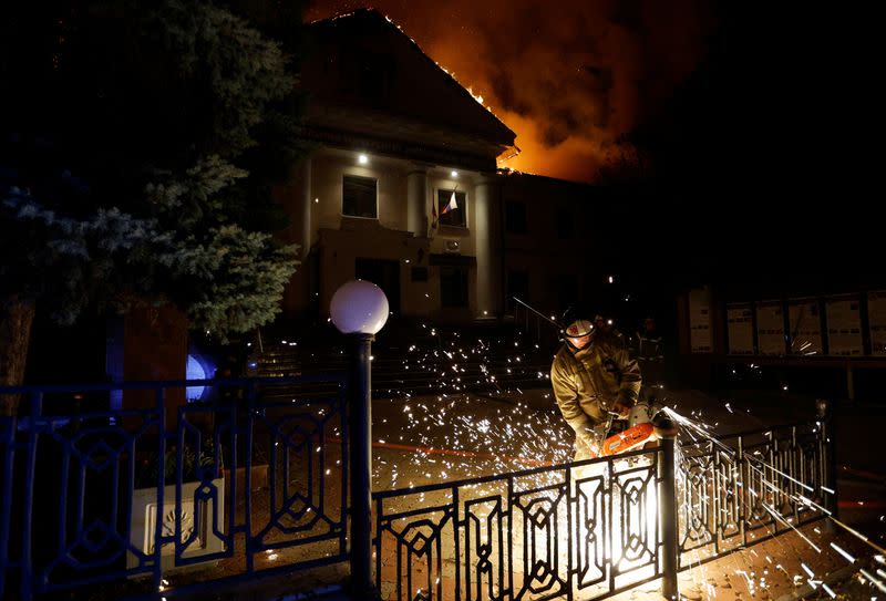 Firefighters extinguish a fire in the university building following a reported shelling in Donetsk