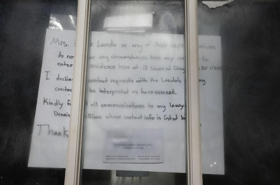 Sign on the home’s front door claiming the Landas do not have Flores’ consent to enter the home they had bought. BRIGITTE STELZER