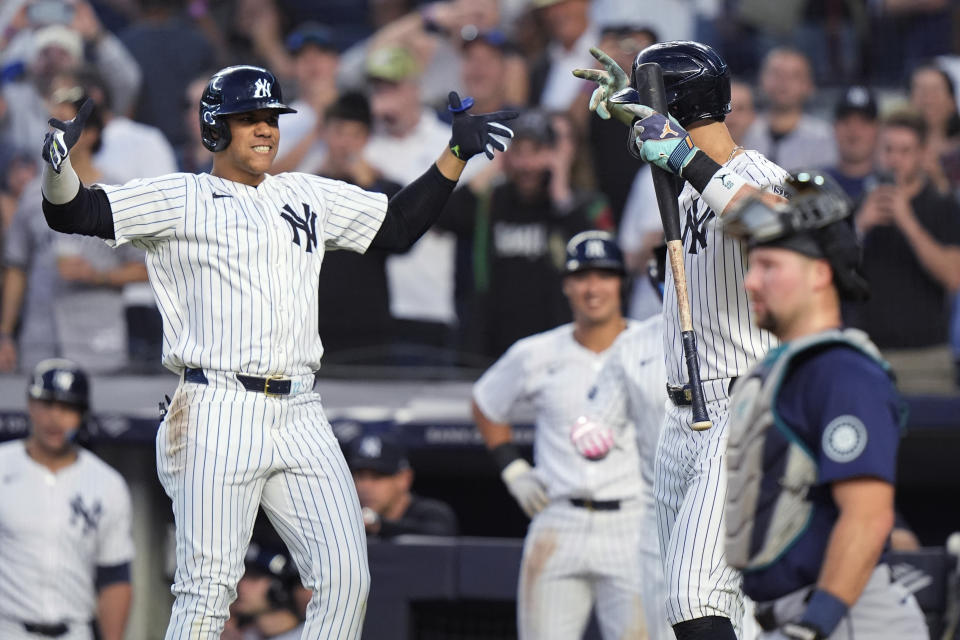 New York Yankees' Juan Soto, left, celebrates withAaron Judge after hitting a two-run home run against the Seattle Mariners during the third inning of a baseball game Wednesday, May 22, 2024, in New York. (AP Photo/Frank Franklin II)