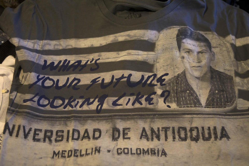 A shirt from the clothing line "Escobar Henao," covered with the image of Colombia's late drug lord Pablo Escobar's high school ID, and reading "What's your future looking like?," sits on display in the home of Escobar's son, Sebastian Marroquin, in Buenos Aires, Argentina, Friday, Aug. 17, 2012. Marroquin, who legally changed his name and moved to Argentina in 1994 with his mother Maria Valeria Henao after his father was killed, says he created the collection as a way to send a message of peace and reflection about his family's history. (AP Photo/Eduardo Di Baia)