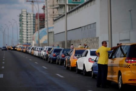 Cars line up for gas at the seafront Malecon in Havana