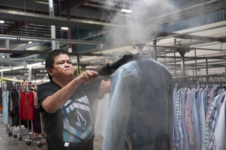 Yolanda Malolos steams a jacket at subscription clothing rental company Le Tote's warehouse in Stockton