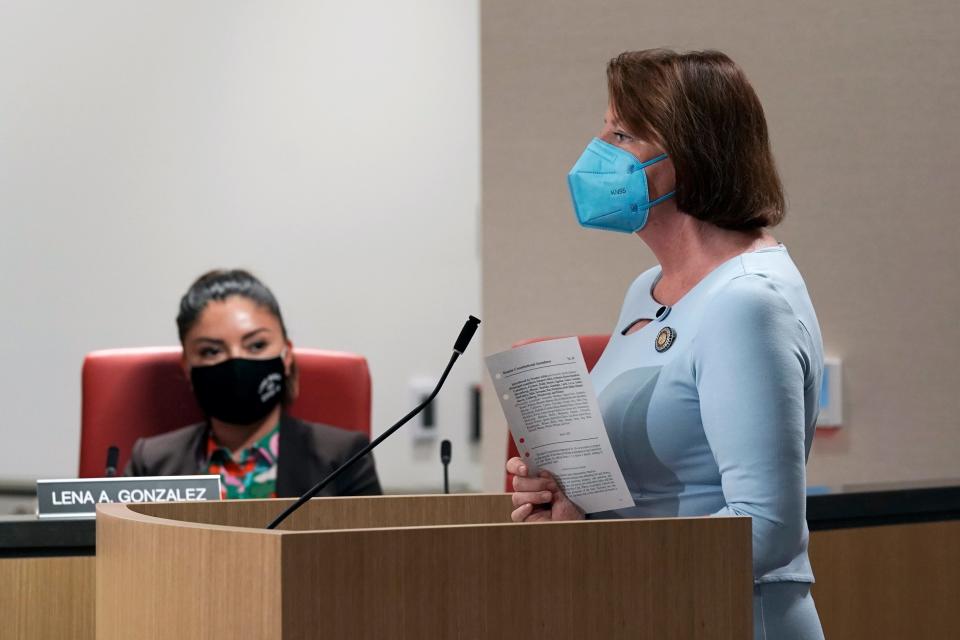 State Sen. President Pro Tempore Toni Atkins, right, displays a copy of her proposed amendment to the state constitution that would protect the right to an abortion and contraceptives during a hearing on the measure in Sacramento, Calif., Tuesday, June 14, 2022. The bill was approved by two legislative committees. It must get a two-thirds vote in the state Assembly and Senate before June 30 to qualify for the November ballot.