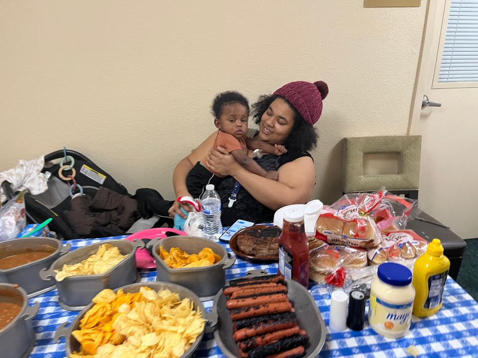 Daisha Harper holds her son, Zaire Spraggins, at a local motel, in front of the food she made for former residents of the Latitude Five25 apartments like herself. Harper and Spraggins were one of 154 households evacuated from Latitude Five25 apartments on Christmas Day due to uninhabitable conditions at the twin apartment towers on Columbus' Near East Side.