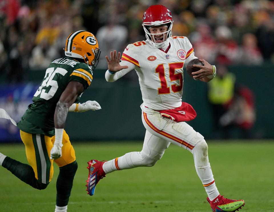 Kansas City Chiefs quarterback Patrick Mahomes (15) scrambles for yardage before being run out of bounds by Green Bay Packers cornerback Keisean Nixon (25) during the second quarter of their game Sunday, December 3, 2023 at Lambeau Field in Green Bay, Wisconsin.