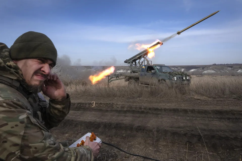 FILE - A Ukrainian officer with the 56th Separate Motorized Infantry Mariupol Brigade fires rockets from a pickup truck at Russian positions on the front line near Bakhmut in Ukraine’s Donetsk region on March 5, 2024. The outgunned and outnumbered Ukrainian troops are struggling to halt Russian advances as a new U.S. aid package is stuck in Congress. (AP Photo/Efrem Lukatsky, File)