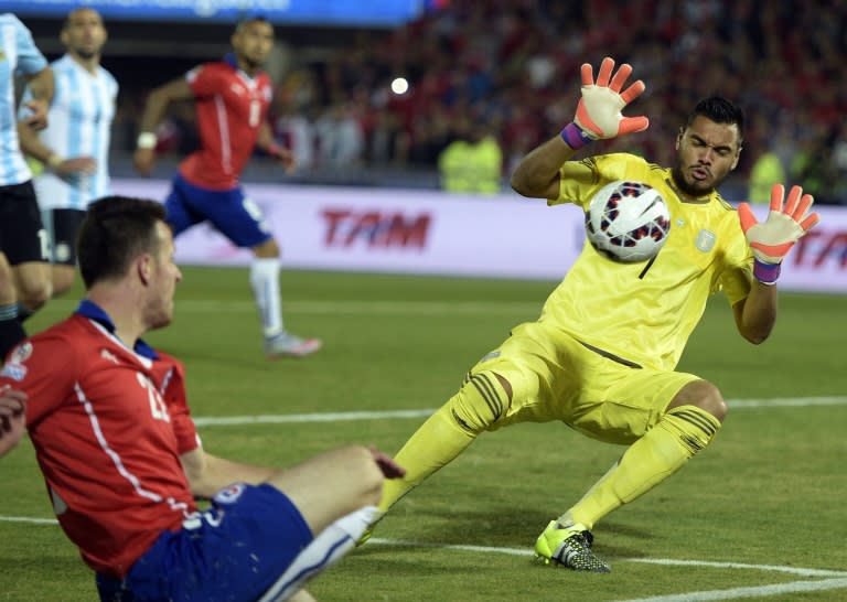 Argentina's goalkeeper Sergio Romero saves a shot by Chile's Angelo Henriquez during their Copa America championship final match, in Santiago, on July 4, 2015