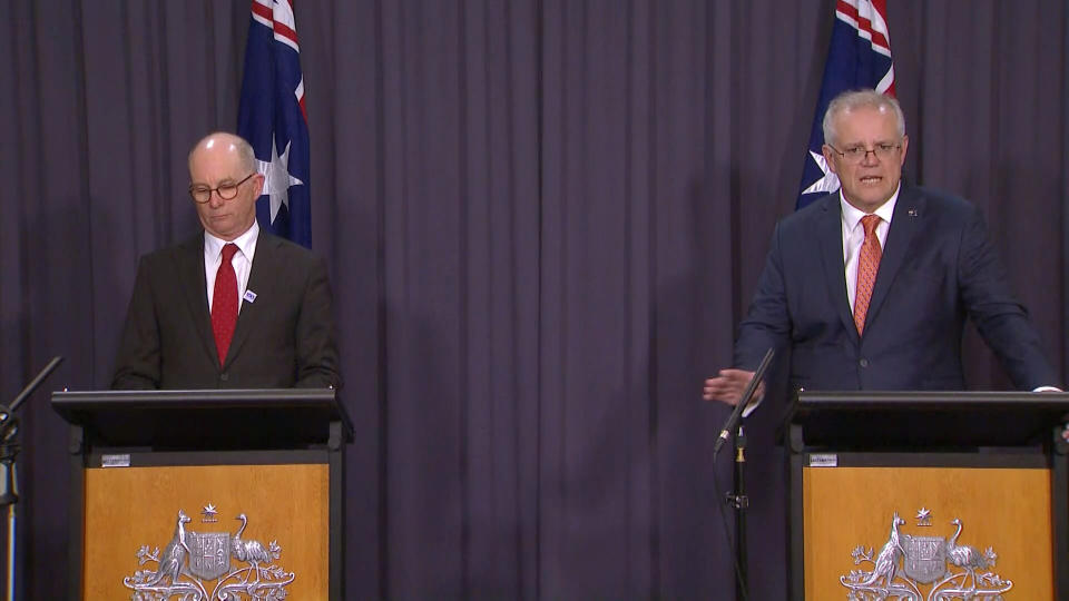 In this image made from video, Australian Prime Minister Scott Morrison, right, with Australian Chief Medical Officer Paul Kelly, speaks during a news conference in Canberra, Australia, Thursday, April 8, 2021. Australia on Thursday become the latest country to restrict use of the AstraZeneca vaccine by recommending that it not be given to people under age 50. (SBS via AP)