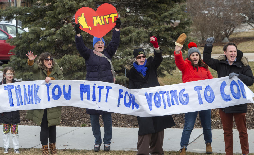 A group gathers on Center Street in Provo, Utah for a rally supporting Sen. Mitt Romney, R-Utah, Wednesday, Feb. 5, 2020. Republicans in the state are unusually divided on the president, so while some were heartened to see Romney cast what he described as an agonizing vote dictated by his conscience, Trump supporters were left angry and frustrated. (Rick Egan/The Salt Lake Tribune via AP)