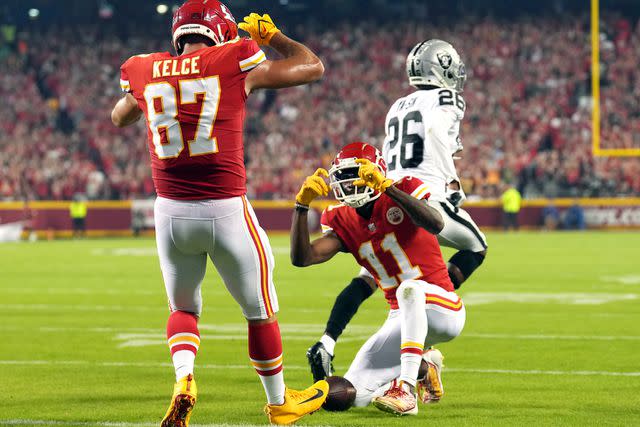 <p>Jason Hanna/Getty</p> Travis Kelce #87 of the Kansas City Chiefs poses for Marquez Valdes-Scantling #11 after scoring a touchdown during the 1st half of the game against the Las Vegas Raiders at Arrowhead Stadium on October 10, 2022 in Kansas City, Missour