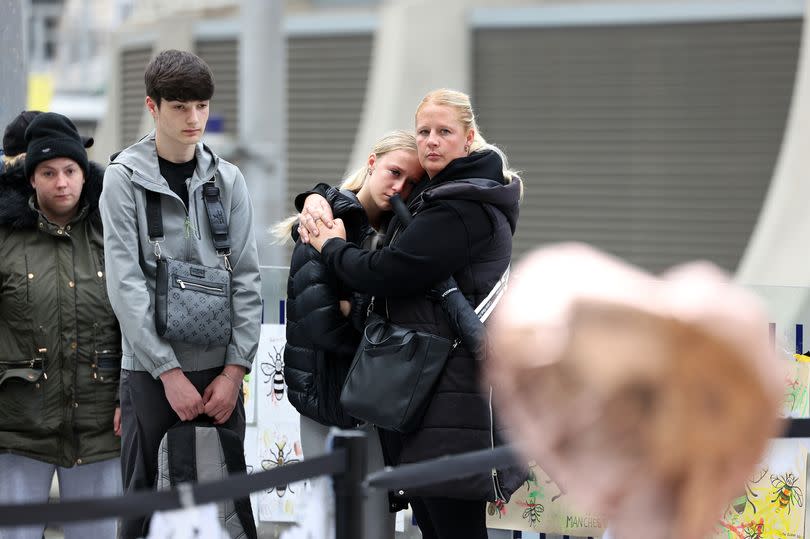 People gather at Victoria station to remember the Manchester Arena bombing seven years on