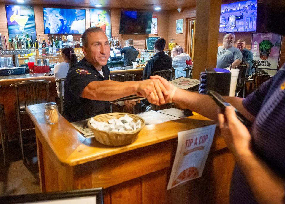 Lafayette Police Chief Monte Potier seats customers as the Lafayette Police Officers wait tables at Deano's Pizza, with tips going to Boys and Girls Clubs. Boys & Girls Clubs of Acadiana, which has seven clubs in six parishes, focuses on academic success, healthy lifestyles and habits, and good character and leadership.