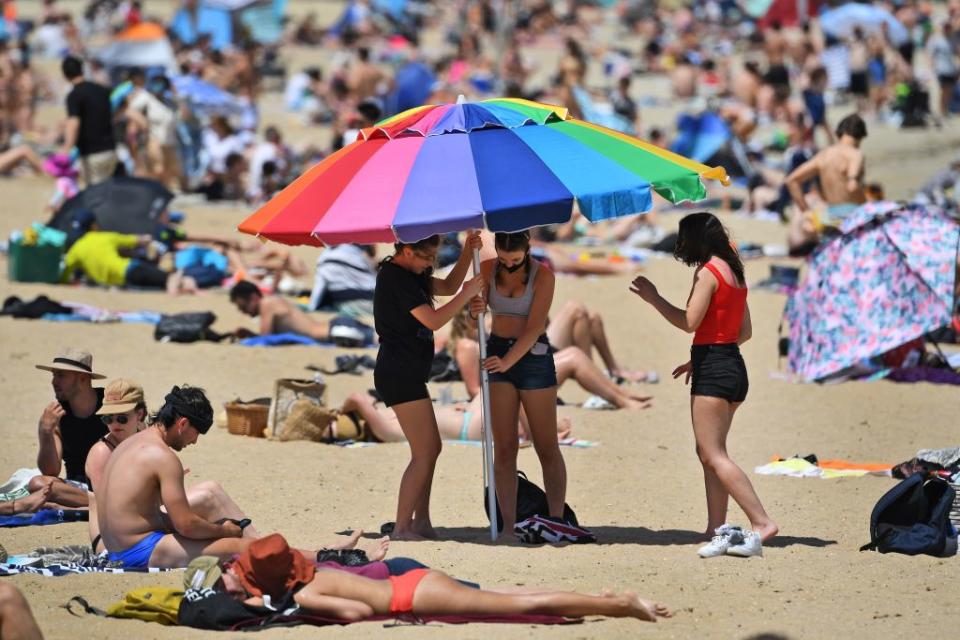 People enjoy the warm weather on Melbourne's St Kilda Beach on Tuesday. Source: AFP via Getty