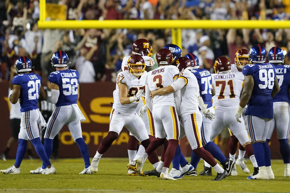 Members of the Washington Football Team celebrate kicker Dustin Hopkins' (3) winning field goal against the New York Giants at the end of an NFL football game, Thursday, Sept. 16, 2021, in Landover, Md. Washington won 30 - 29. (AP Photo/Al Drago)