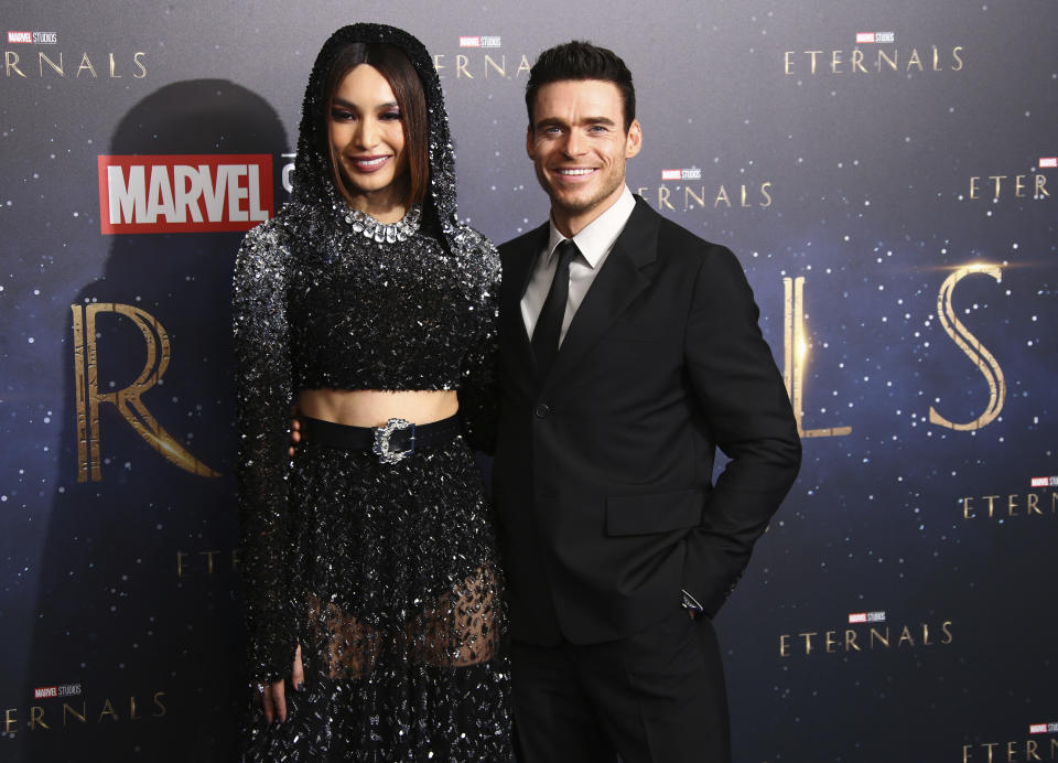 Gemma Chan, left, and Richard Madden pose for photographers upon arrival at the premiere of the film 'Eternals' on Wednesday, Oct. 27, 2021, in London. (Photo by Joel C Ryan/Invision/AP)