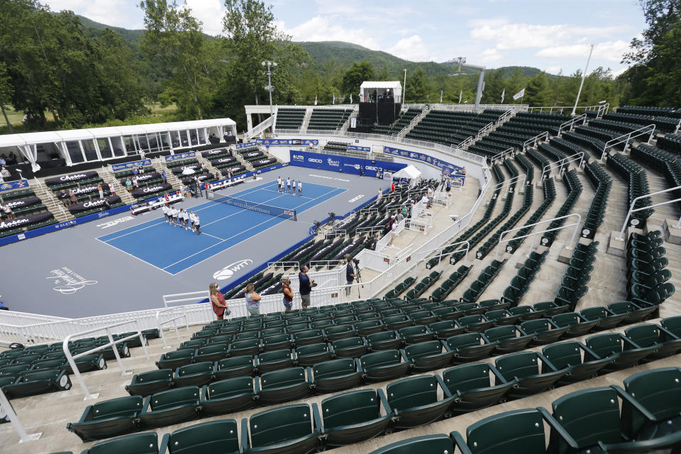 The Springfield Lasers, left, and Orlando Storm, right, are introduced at the start of the World Teamtennis tournament at an empty tennis arena at The Greenbrier Resort Sunday, July 12, 2020, in White Sulphur Springs, W.Va. (AP Photo/Steve Helber)