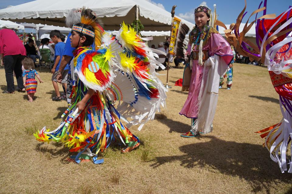 Maycie TwoCrow of Leelanau County watches what's known as a fancy dancer at last year's Kchi Wiikwedong Anishinaabek Pow Wow, a fixture for 30 years at the National Cherry Festival. The pow wow culminates with the crowing of a princess.