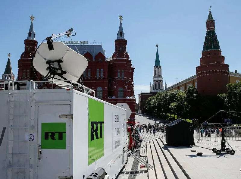 FILE PHOTO: Vehicles of Russian state-controlled broadcaster Russia Today are seen near the Red Square in central Moscow