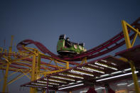 A man wears a mask on an amusement ride at the Mississippi State Fair, Wednesday, Oct. 7, 2020, in Jackson, Miss. At the fair, which is held every year in October and attracts people from across the racial spectrum, the vast majority of Black people are wearing masks. Most white people do not. (AP Photo/Wong Maye-E)