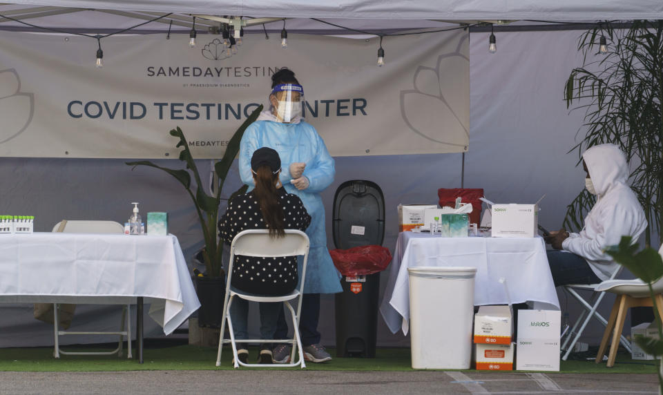 A mid-turbinate nasal swab PCR test is administered at a same-day coronavirus testing site in Los Angeles on Tuesday, Jan. 5, 2021. Los Angeles is the epicenter of California's surge that is expected to get worse in coming weeks when another spike is expected after people traveled or gathered for Christmas and New Year's. (AP Photo/Damian Dovarganes)