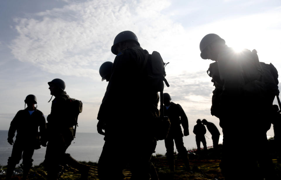 Soldiers from the U.S. 75th Ranger Regiment, in period dress stand on the overlook after climbing the cliffs of Pointe-du-Hoc in Cricqueville-en-Bessin, Normandy, France, Wednesday, June 5, 2019. During the American assault of Omaha and Utah beaches on June 6, 1944, U.S. Army Rangers scaled the 100-foot cliffs to seize German artillery pieces that could have fired on the American landing troops. (AP Photo/Thibault Camus)