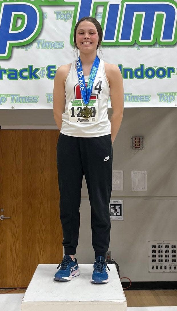 Katelyn Lehnen stands atop the podium at the Illinois Top Times meet last weekend in Bloomington.