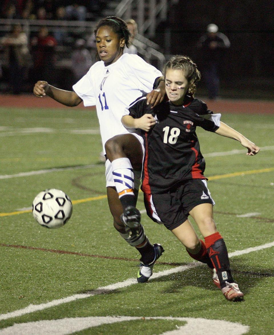Acton Boxborough's Hayley Brock, left, fights for the ball with Whitman Hanson's Megan O'Leary.