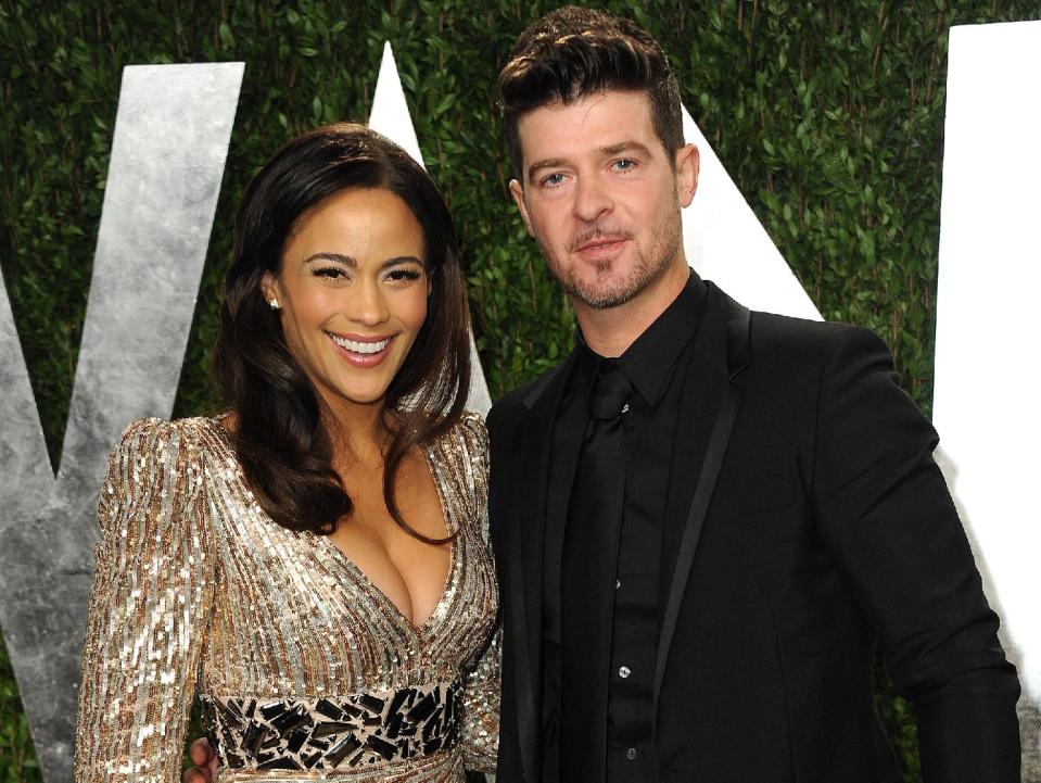 FILE - In this Feb. 24, 2013 file photo, Paula Patton and Robin Thicke arrive at the 2013 Vanity Fair Oscars Viewing and After Party at the Sunset Plaza Hotel in West Hollywood, Calif. Patton is busy promoting her second film this year, the upcoming romantic comedy “Baggage Claim.” Personally, Patton is relishing the success of her recording artist husband Thicke, whose catchy summer hit “Blurred Lines” has topped Billboard's Hot 100 chart. (Photo by Jordan Strauss/Invision/AP, File)